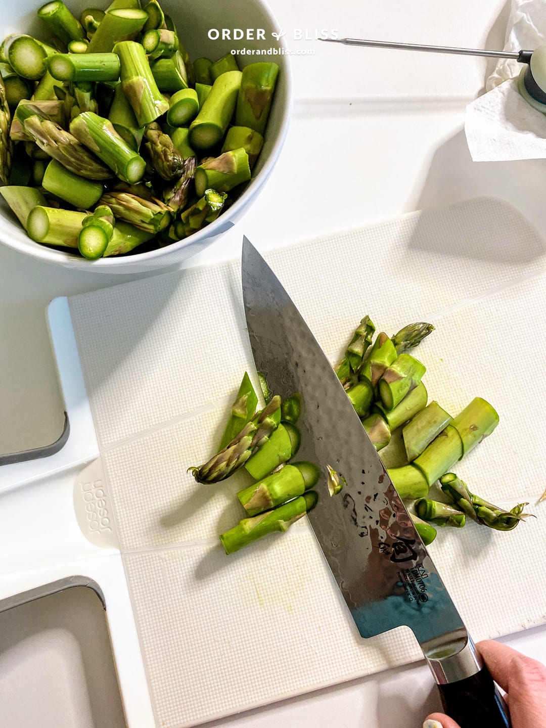 Shun premier chef knife cutting asparagus