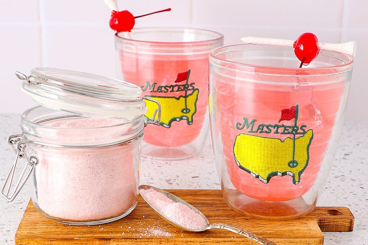 Azalea cocktail with a bright pink hue in a glass.