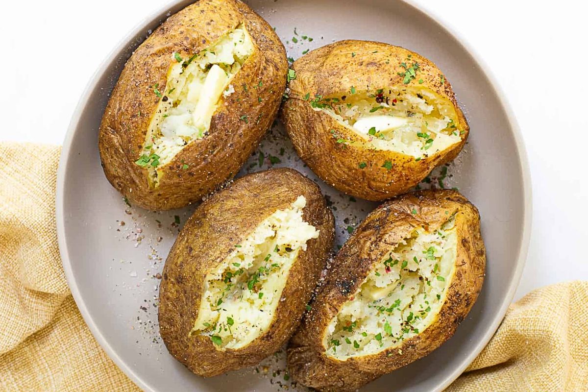 Fluffy baked potato with a crispy, seasoned air-fried skin.