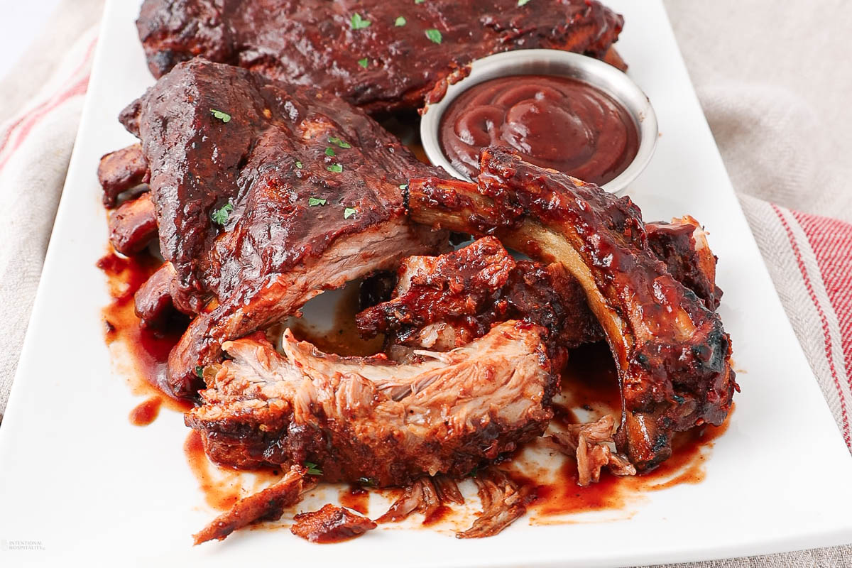 Slow cooker baby back ribs coated in barbecue sauce.