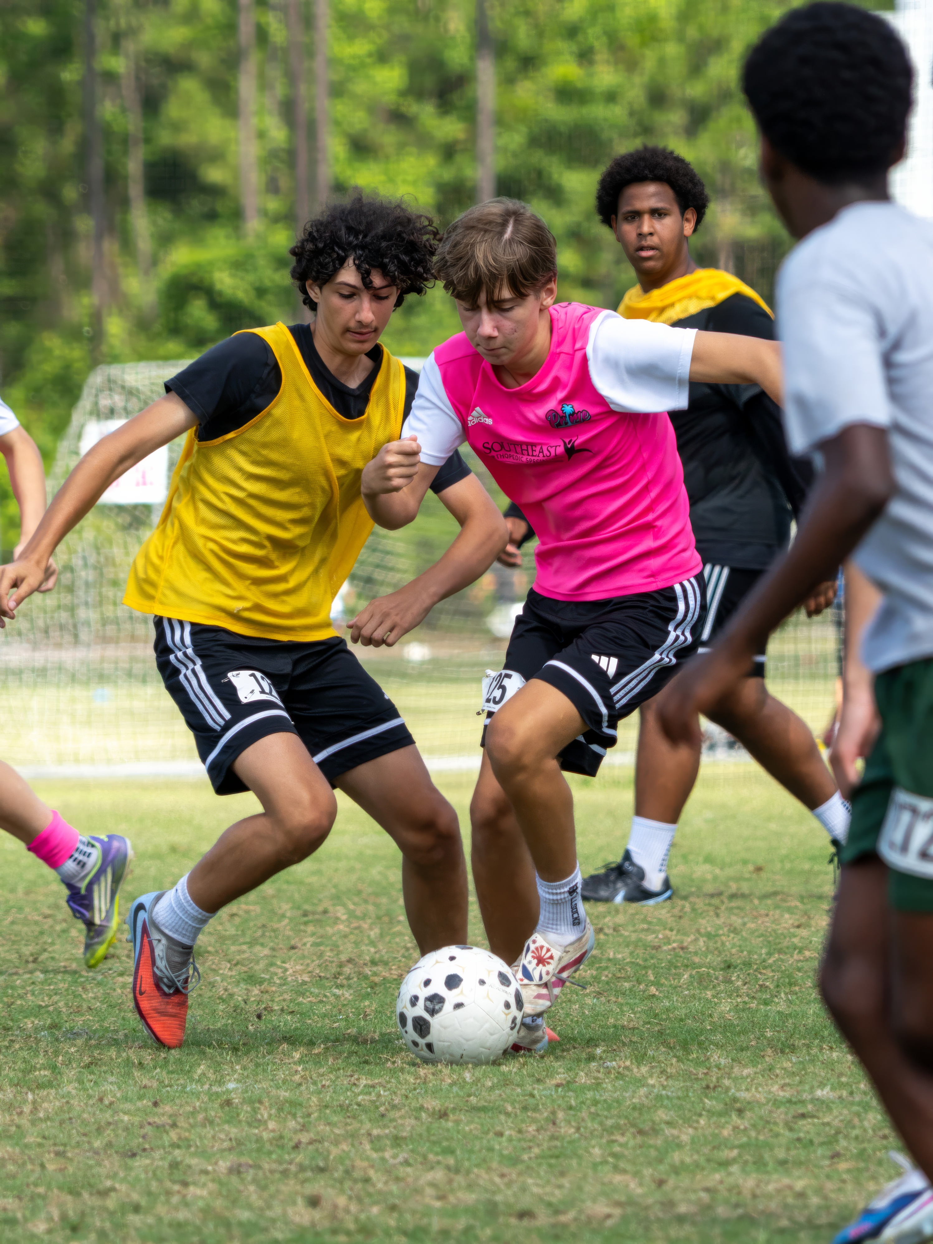 Young Prime Sports athletes battling for the ball in a soccer match