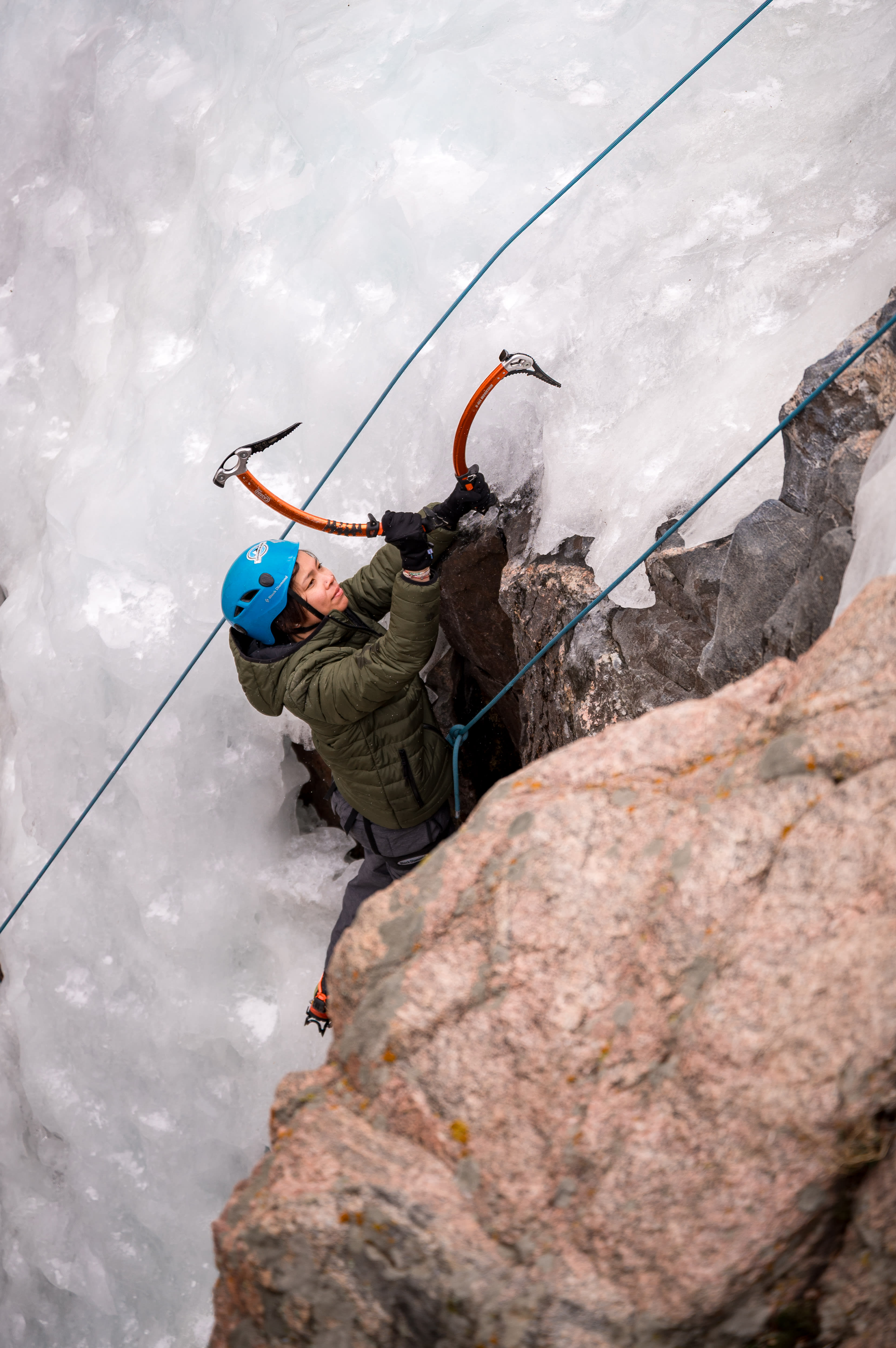 Cruxing in Color ice climbing event — climber portrait