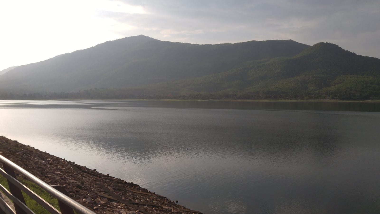 Dimna Lake with green hills and an embankment railing near Jamshedpur