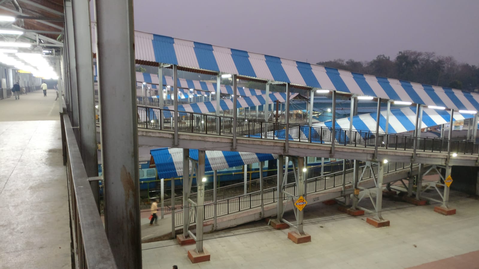 Dhanbad Junction platforms and blue-and-white footbridge photographed in March 2019