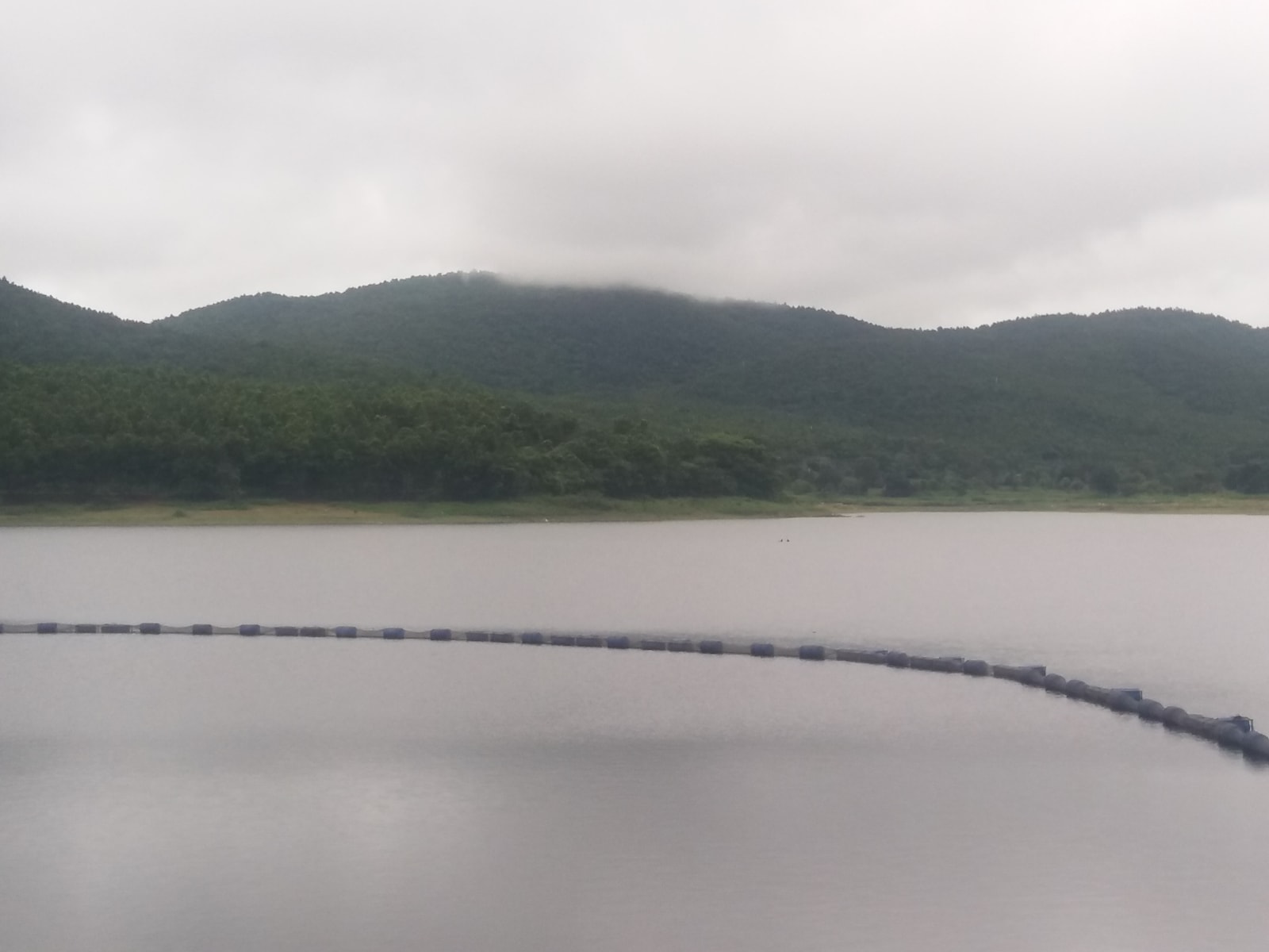 Burudih Lake near Ghatshila with wooded hills and a floating barrier, photographed in October 2022