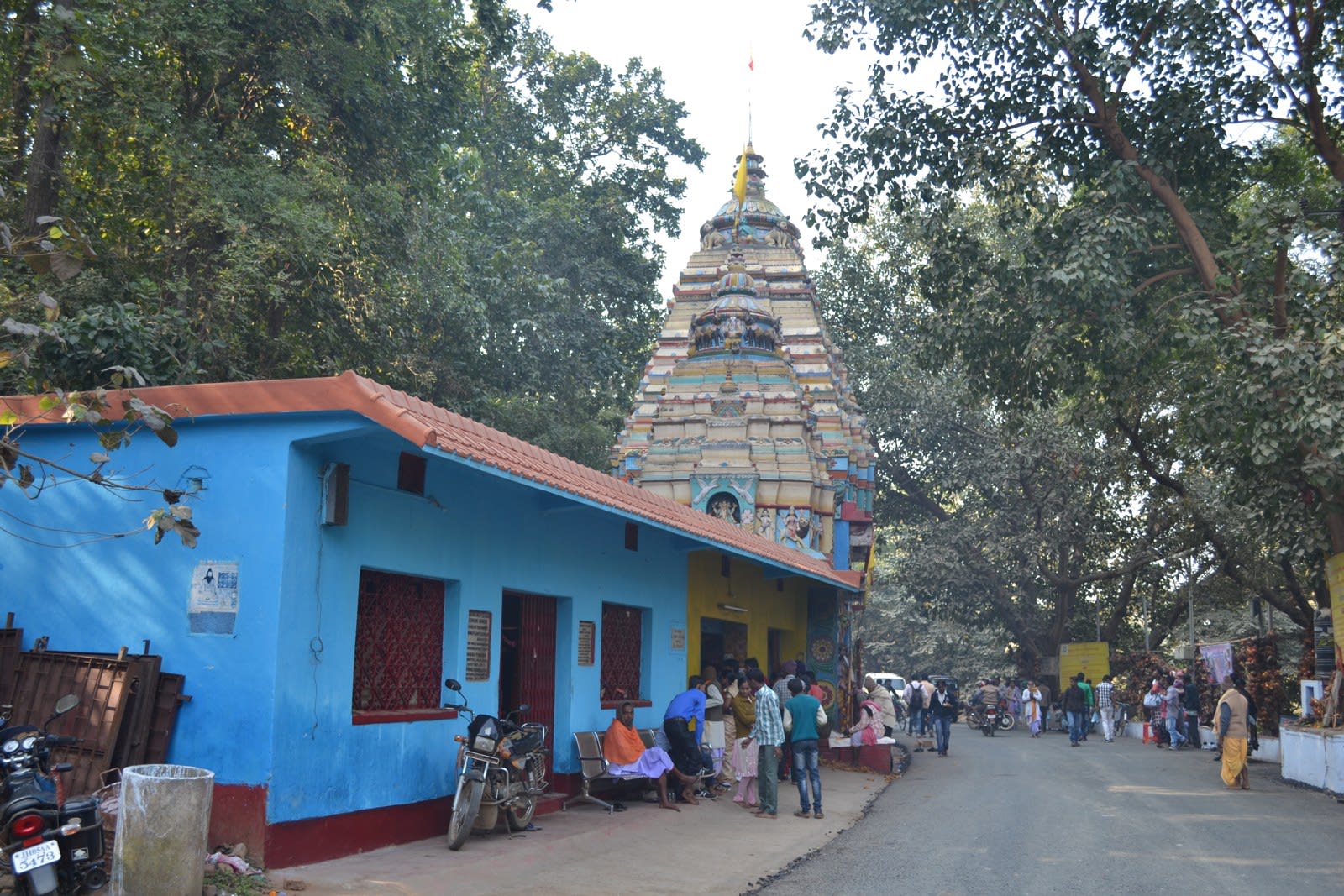 Historical photograph of Rankini Temple at Jadugora showing its colourful tower, entrance-side building and road, December 2013
