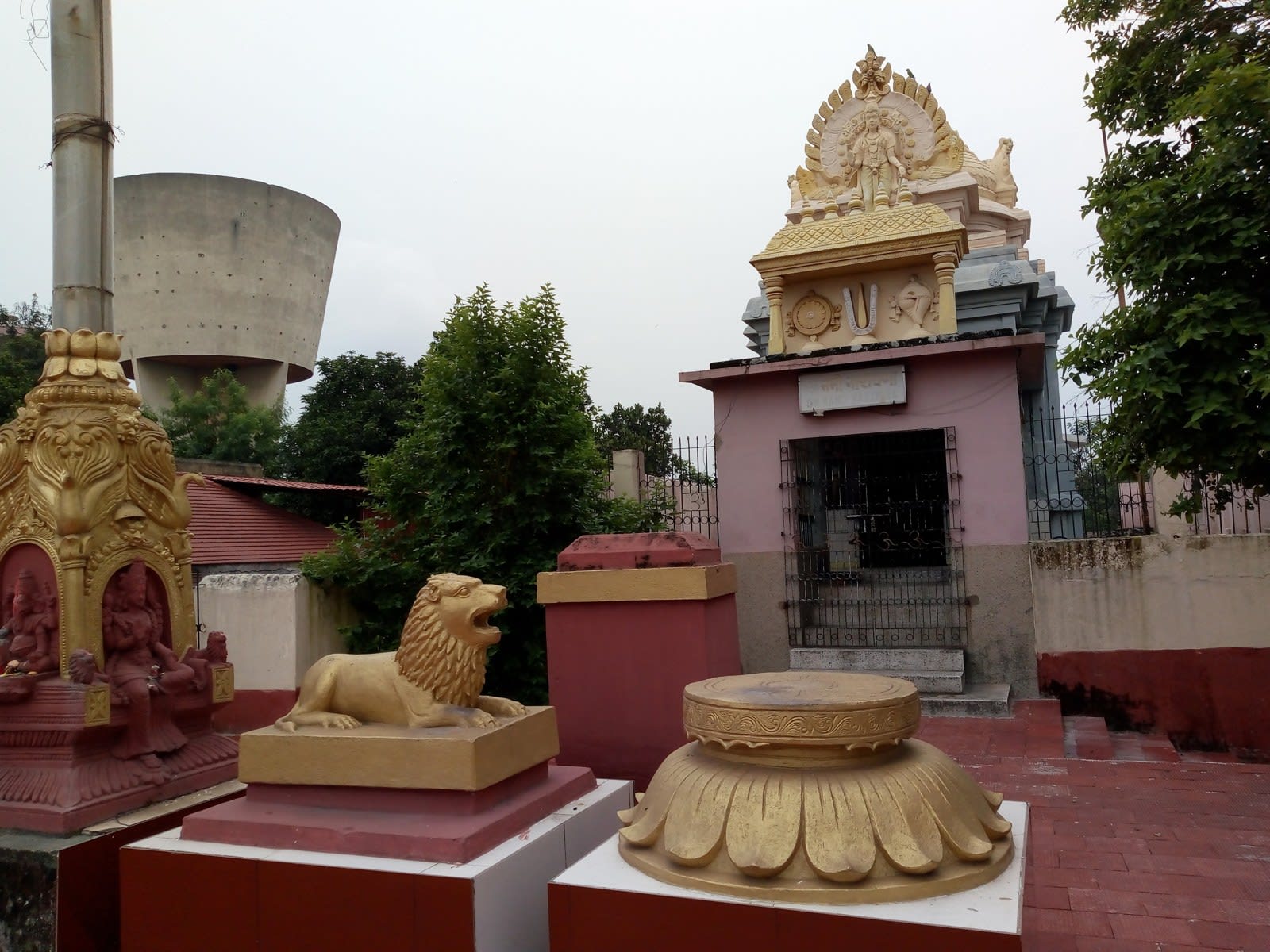 Historical exterior detail of the Bhuvaneshwari temple complex in Telco with sculpted ornaments, courtyard and entrance steps, August 2018