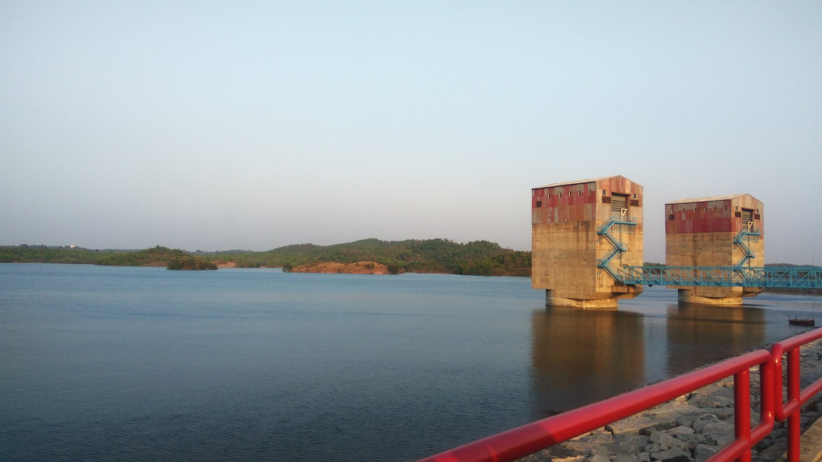 Ajodhya Upper Dam reservoir and control structures behind a railing, photographed in March 2018
