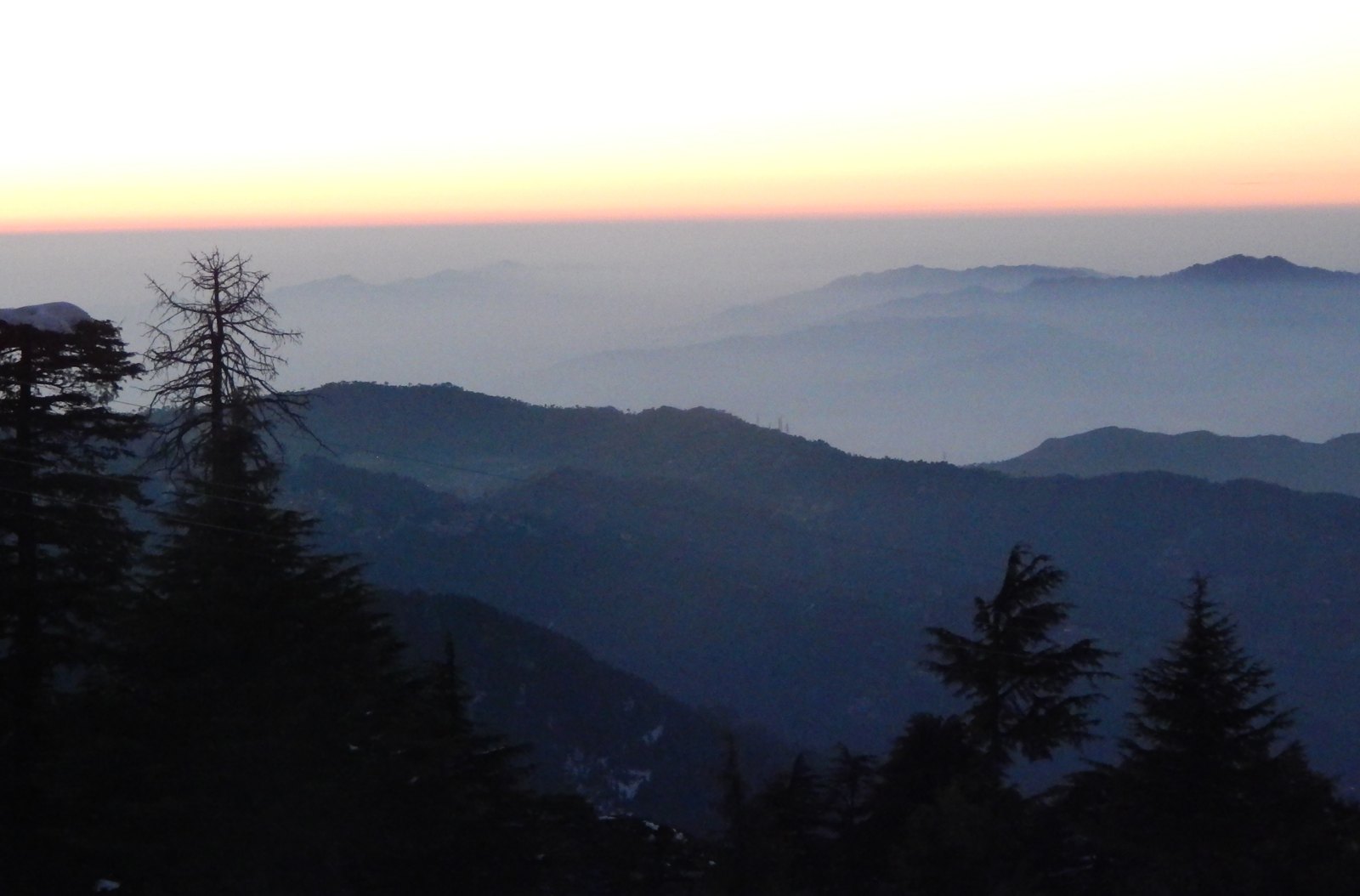 Layered forested hills at sunset in Netarhat, photographed in September 2016
