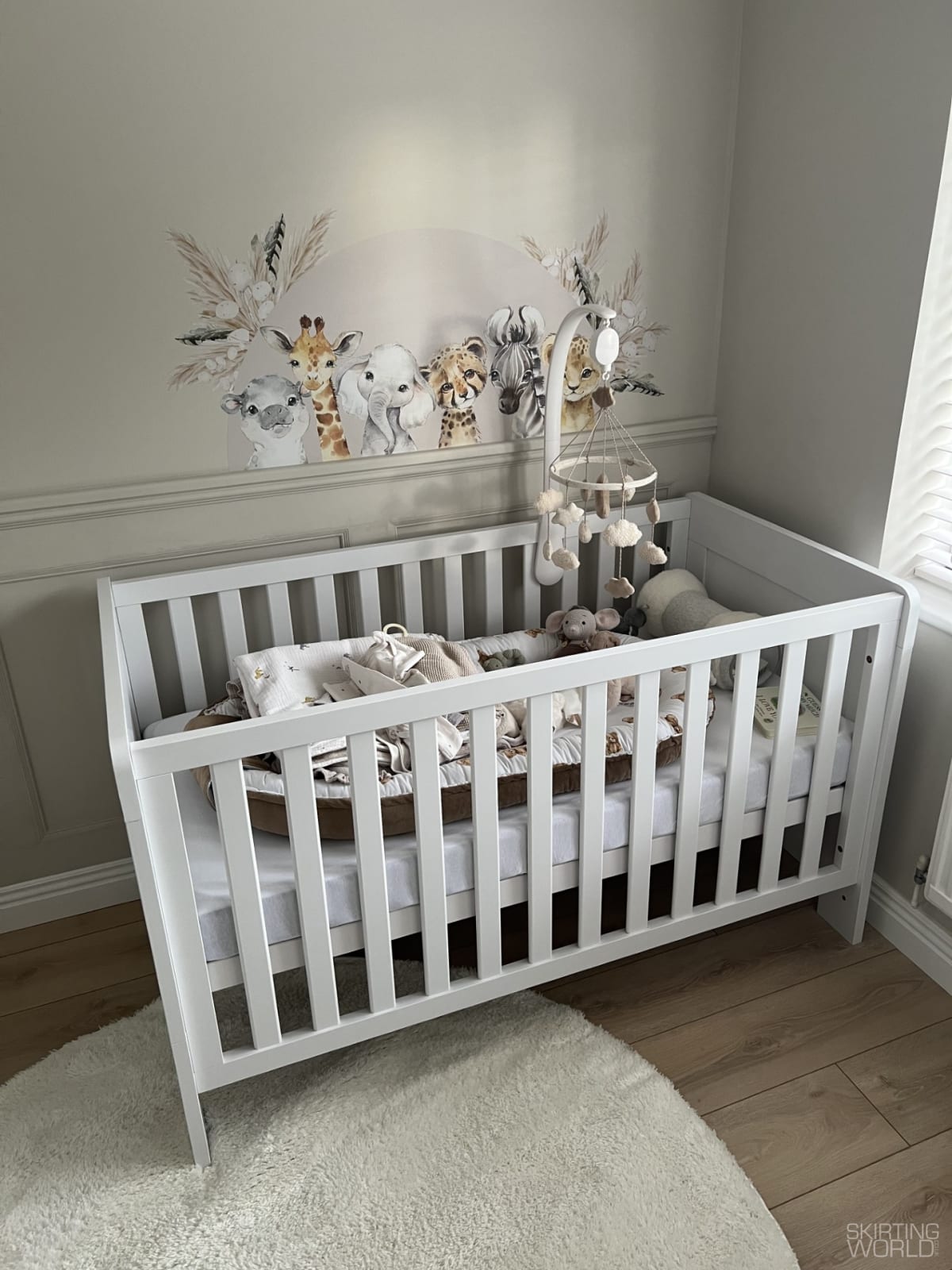 Warm greige bedroom with soft taupe trim and animal decals on the wall