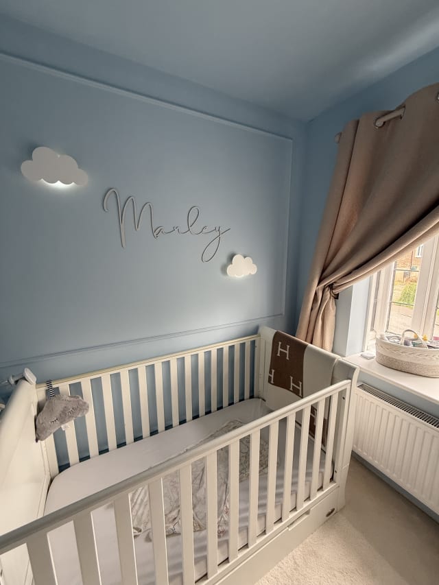 Astragal MDF panel moulding forming large panels on a pale blue nursery wall
