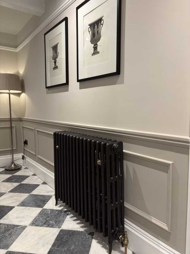 Taupe hallway wainscoting in 324 MDF panel moulding above white skirting, with a cast-iron radiator