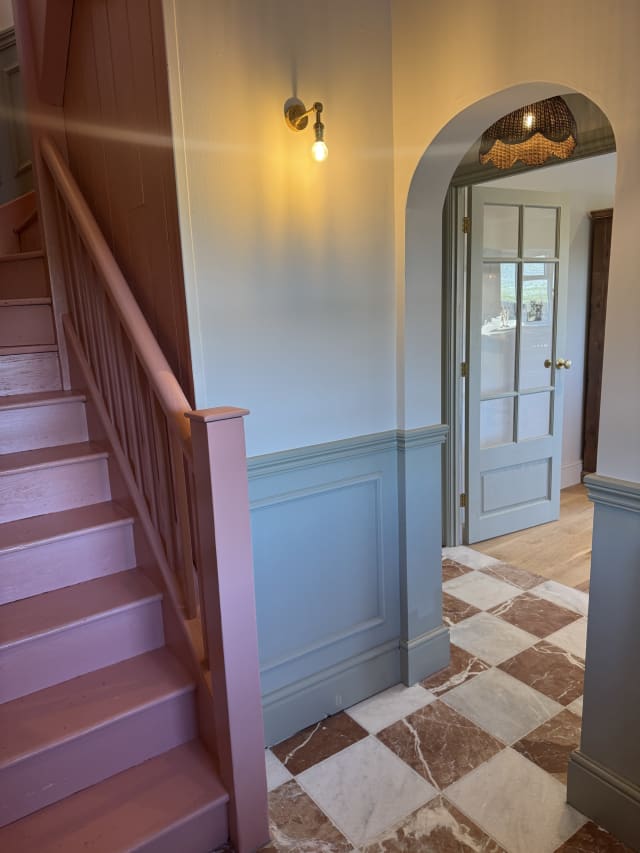 Grey-green wainscoting in Astragal Large panel moulding with an Ogee 2 dado rail, beside a pink staircase