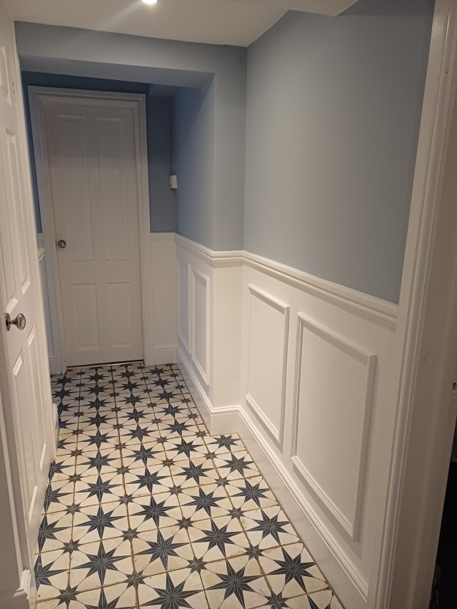 Hallway wainscoting in 324 MDF panel moulding and dado rail, painted white below pale blue walls