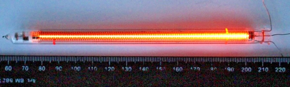 An IN-13 bargraph tube fully lit, lying next to a ruler