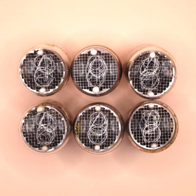 Six used IN-4 Nixie tubes seen from the top, with the digits visible through the dome