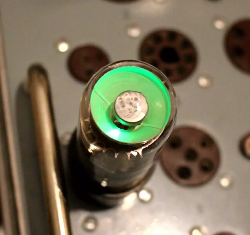 A Soviet 6E5S magic eye lit green on the tester panel, seen from the top
