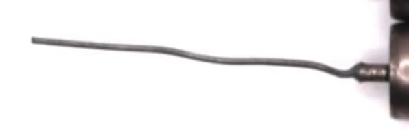 Close-up photo of a K40Y-9 capacitor lead leaving the end of the case, full length but with a bend in the wire