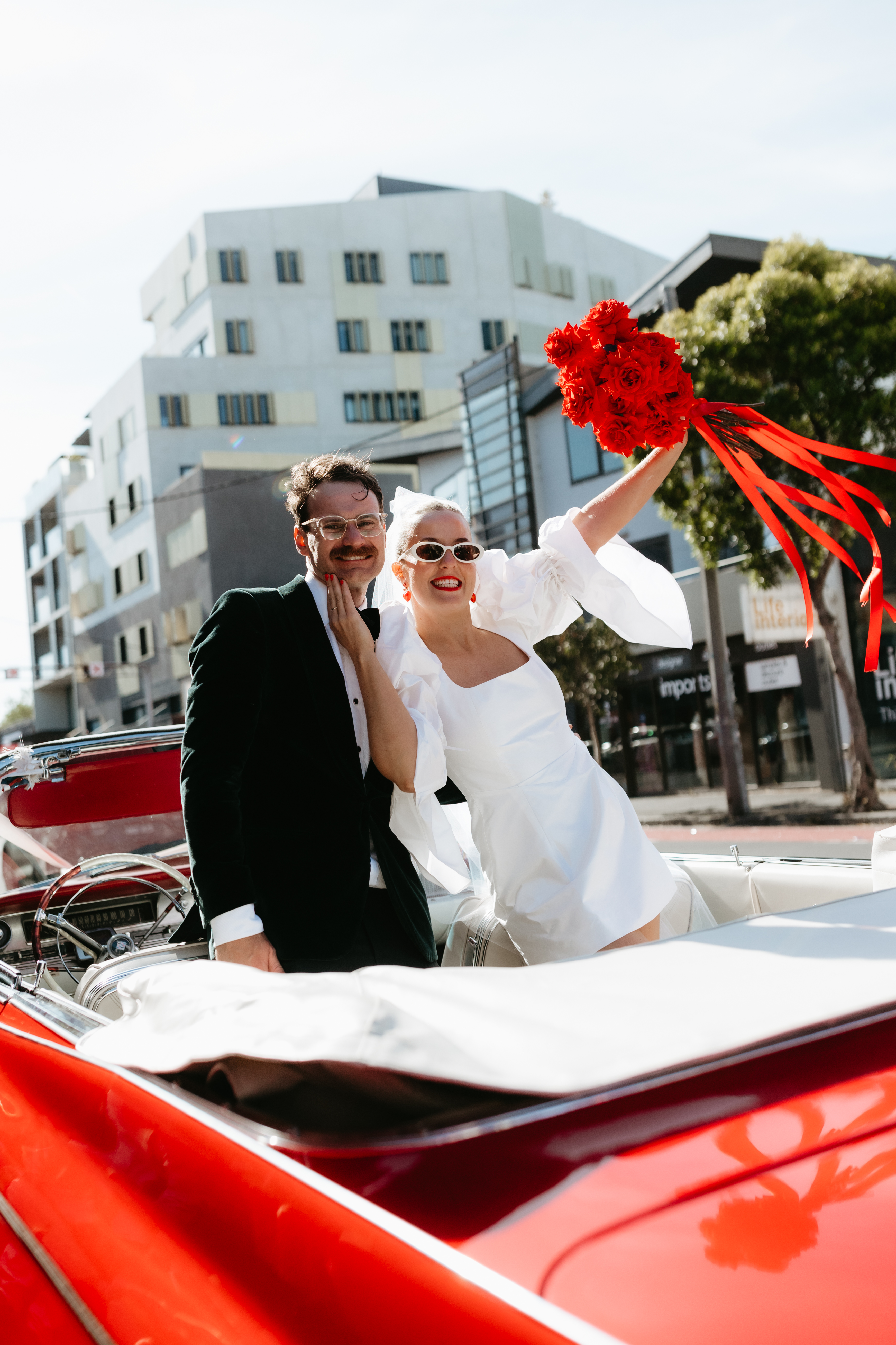 Couple walking Abbotsford laneway in wedding clothes