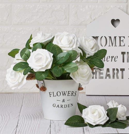 White artificial roses arranged in a planter as home décor