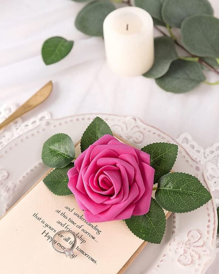 Hot pink real-touch foam roses styled on a place setting