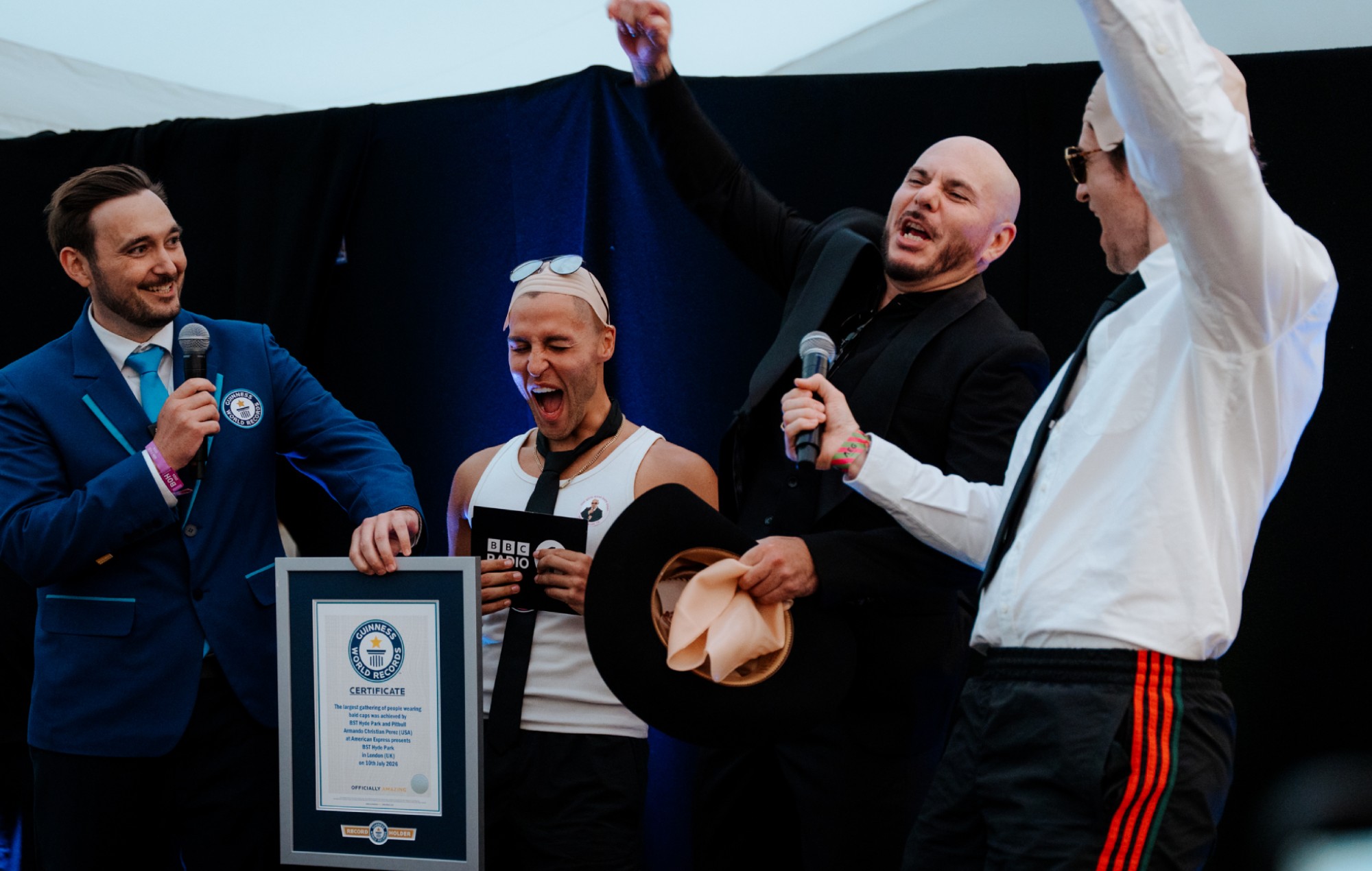 Pitbull Fans Break Guinness World Record for Largest Bald Cap Gathering