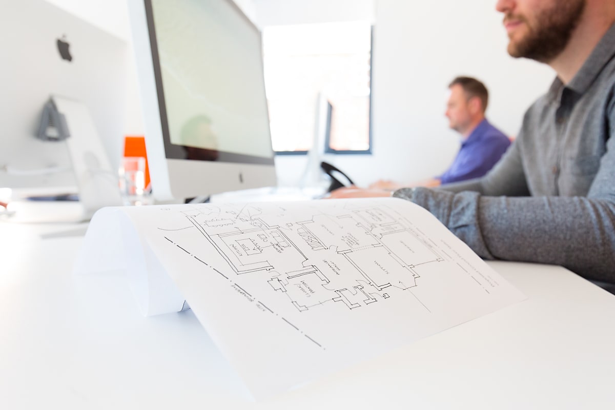 Close up of an architectural sketch on a table in a bright studio space