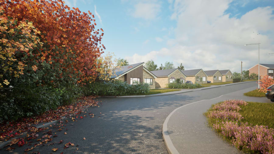 Modern single-storey residential development with stone-clad bungalows along a curved road with autumn landscaping