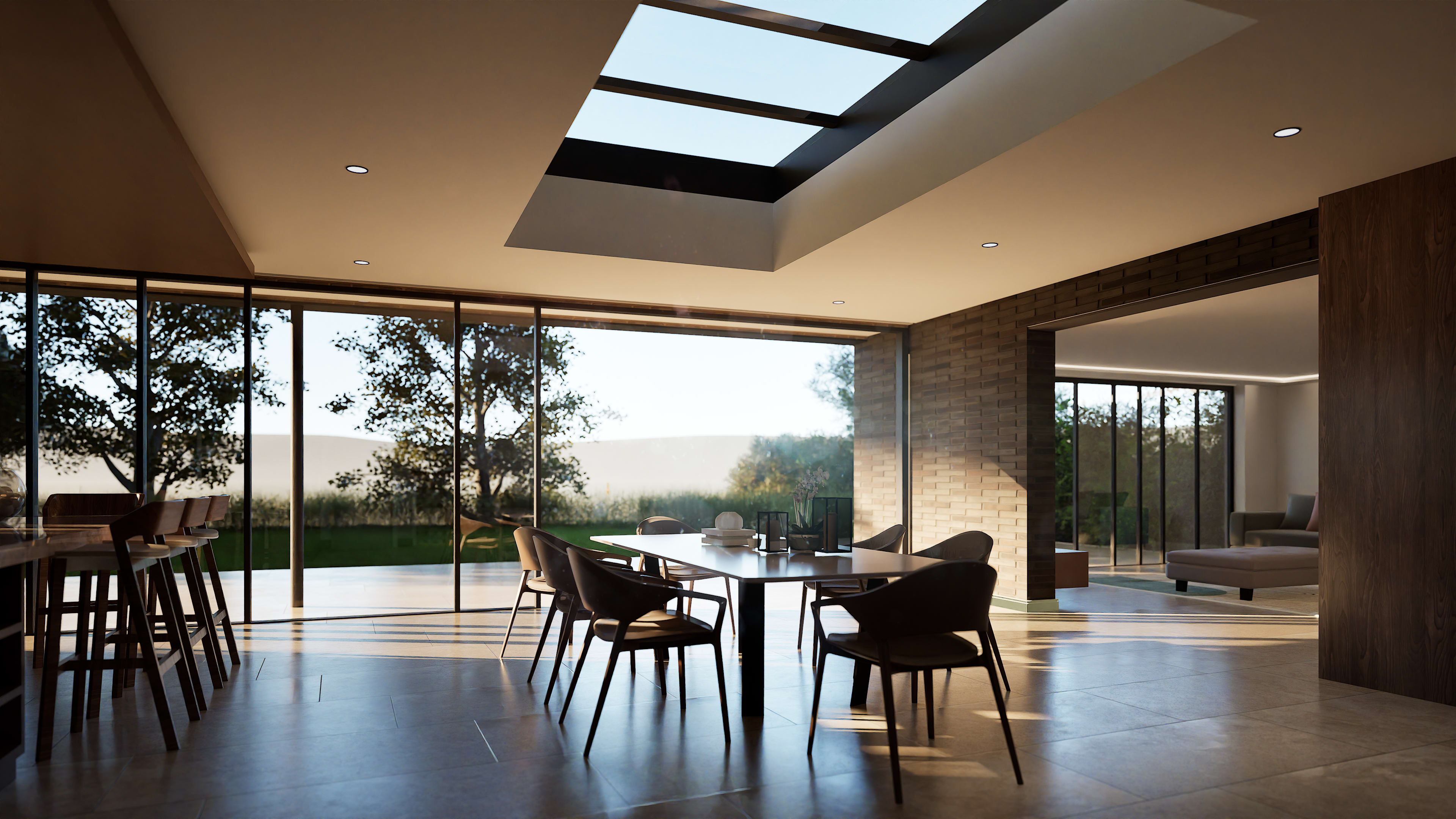 Modern open-plan dining area with skylight, floor-to-ceiling glass walls, dark wood table and chairs, brick accent wall
