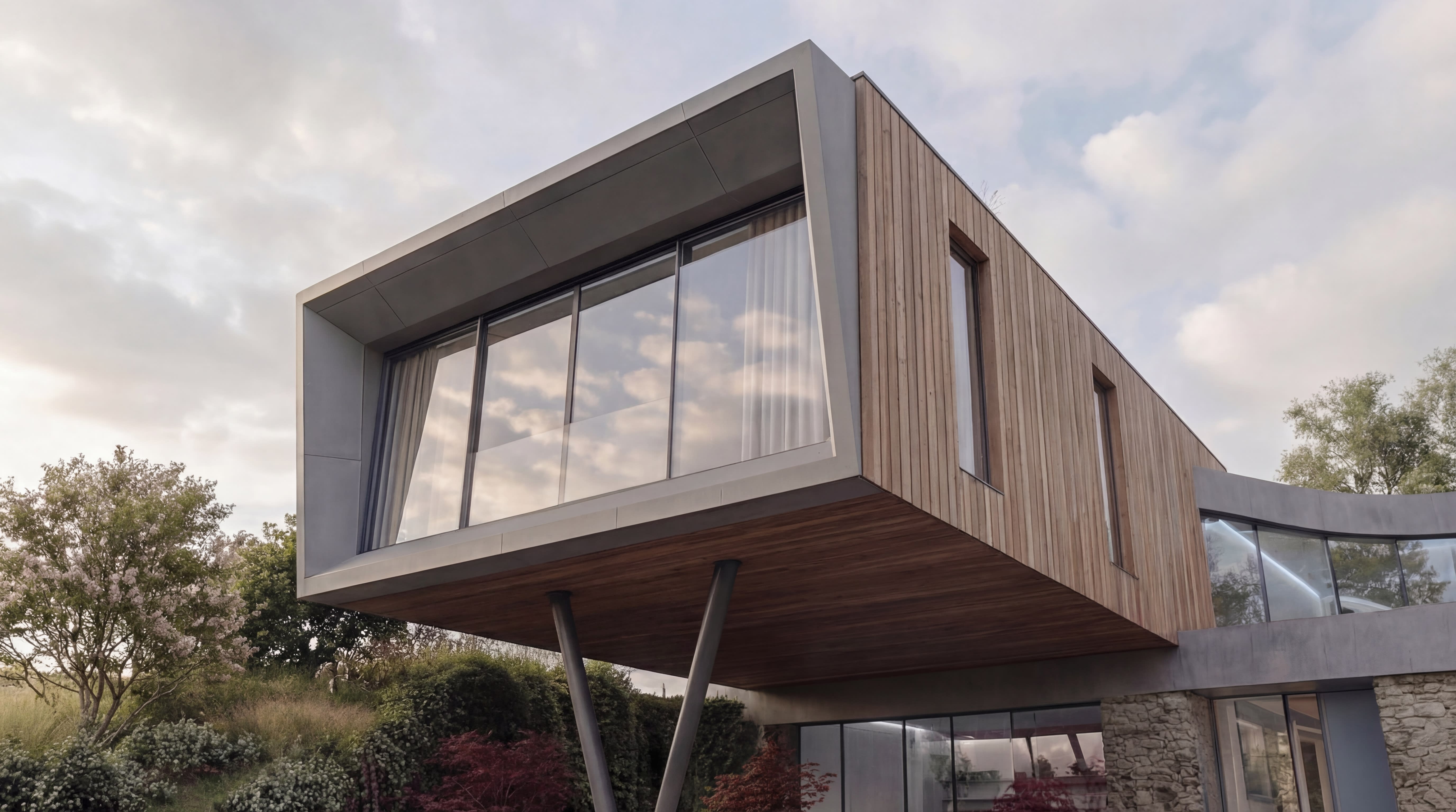 Cantilevered timber-clad upper floor with floor-to-ceiling glazing supported on slender steel columns above a stone base