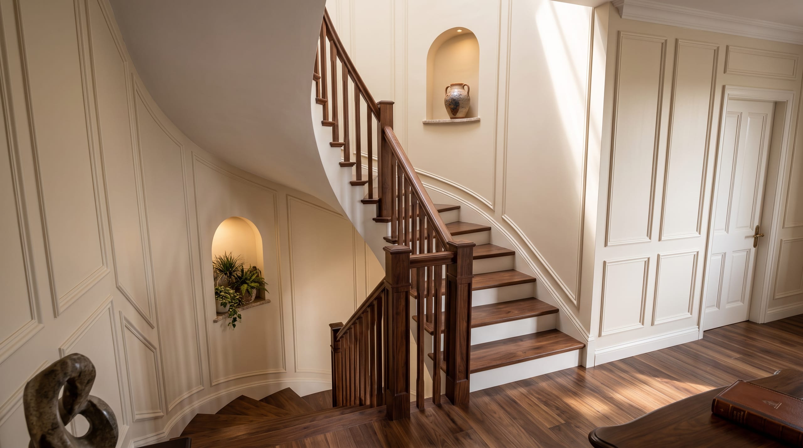 Visualisation of the curved staircase with a timber handrail and niches in the panelled wall