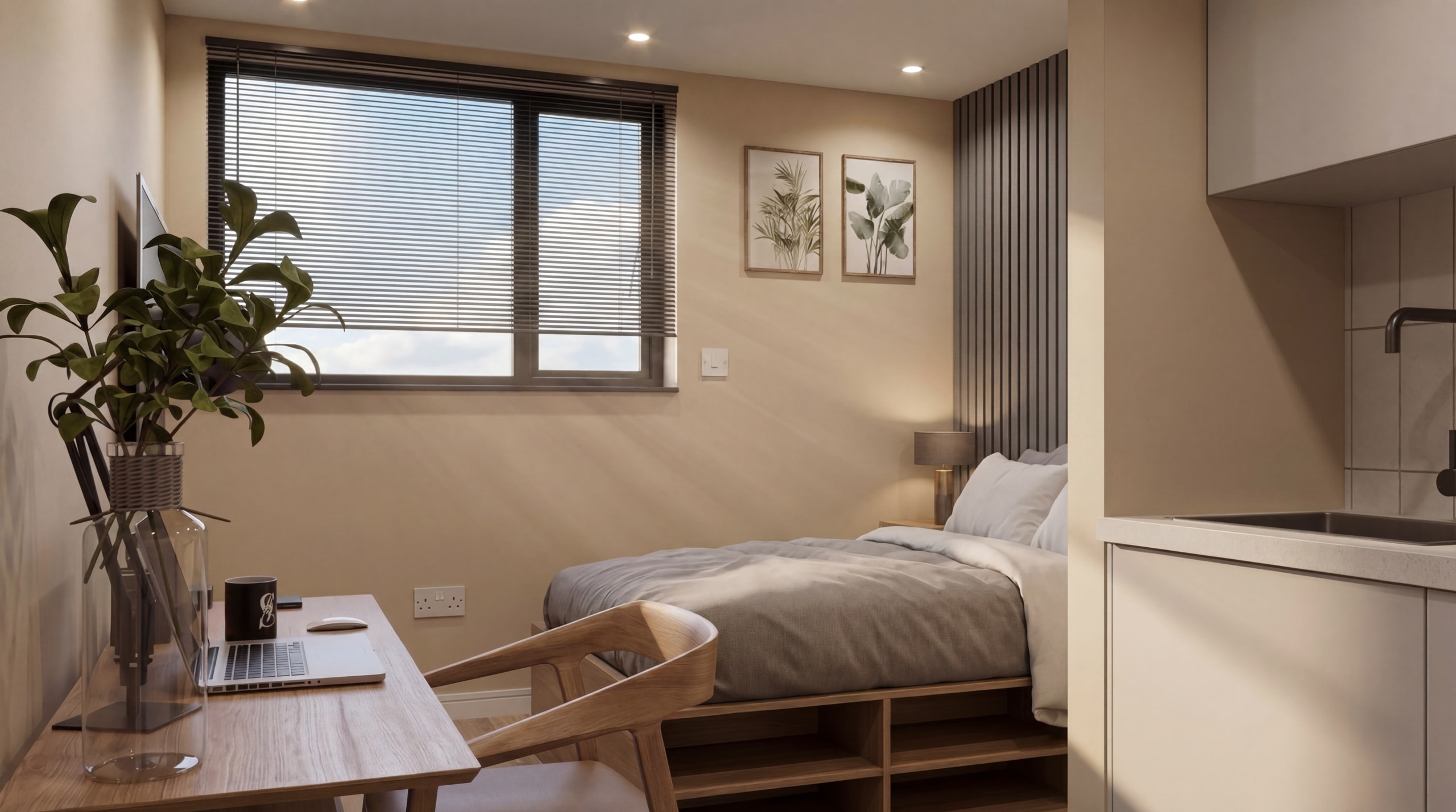 Compact studio room with a double bed, desk by the window and kitchenette
