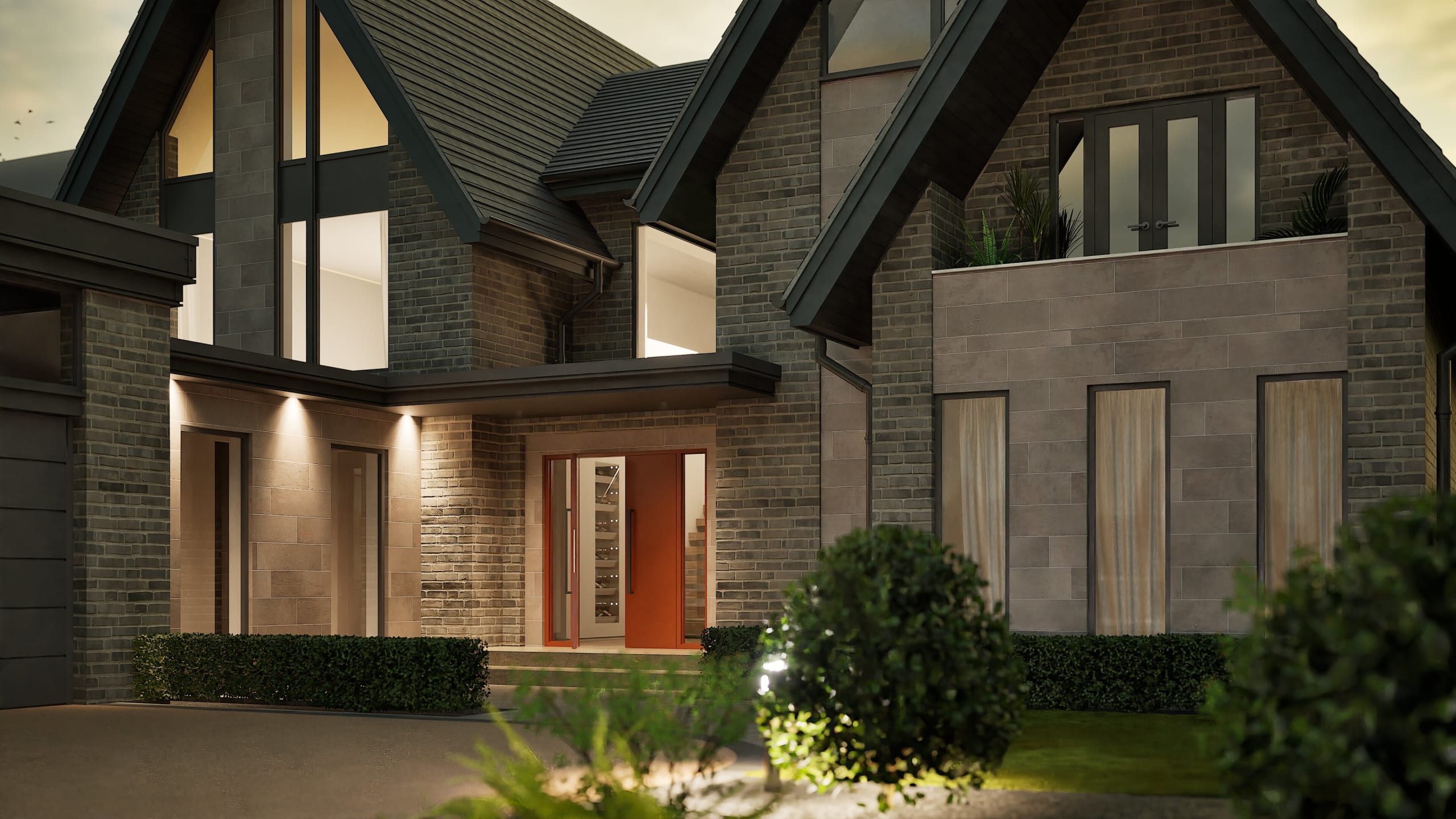 Modern brick home exterior at dusk featuring steep gabled roofs, large windows, and a bold orange front door with sidelights
