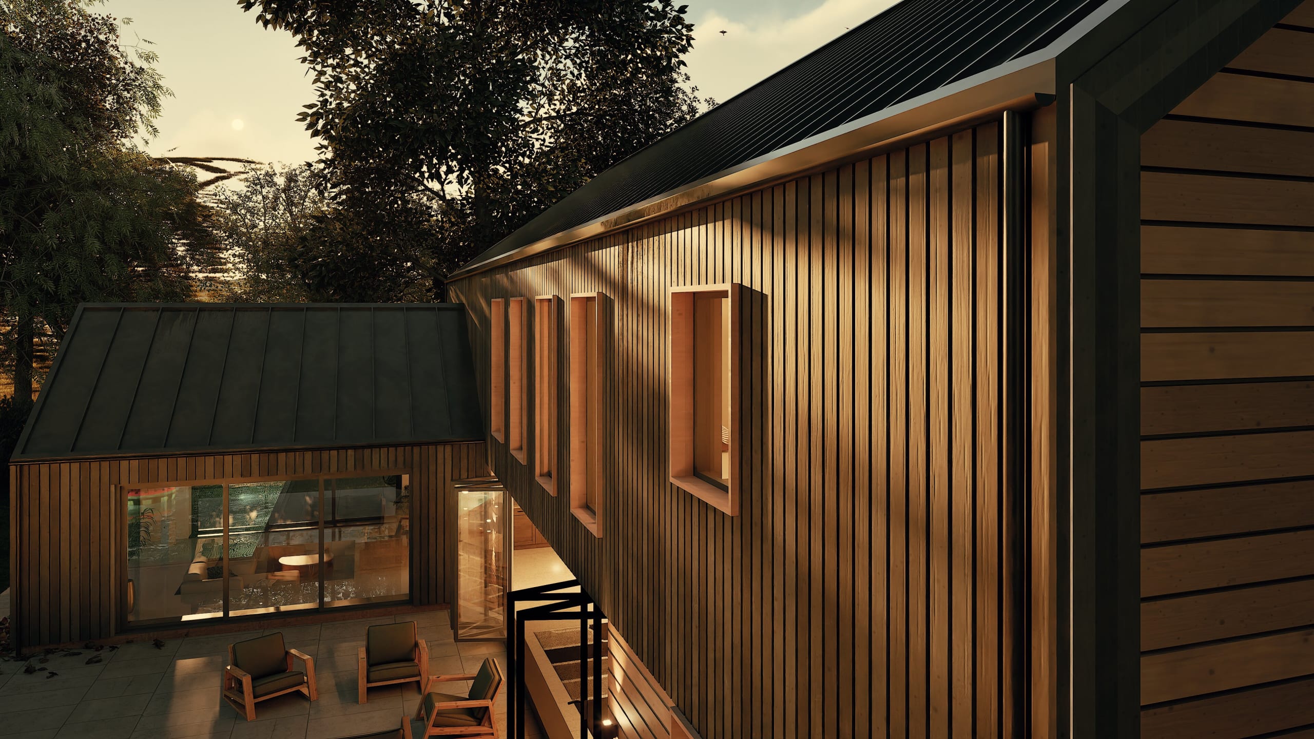 Modern timber-clad building exterior at dusk featuring vertical wood siding, standing seam metal roof, and outdoor terrace