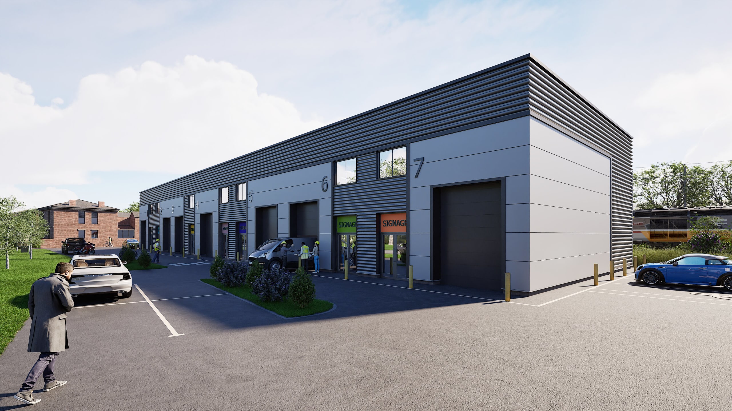 Modern grey industrial warehouse units numbered 3-7 with roller doors, parking area, and workers in high-visibility vests