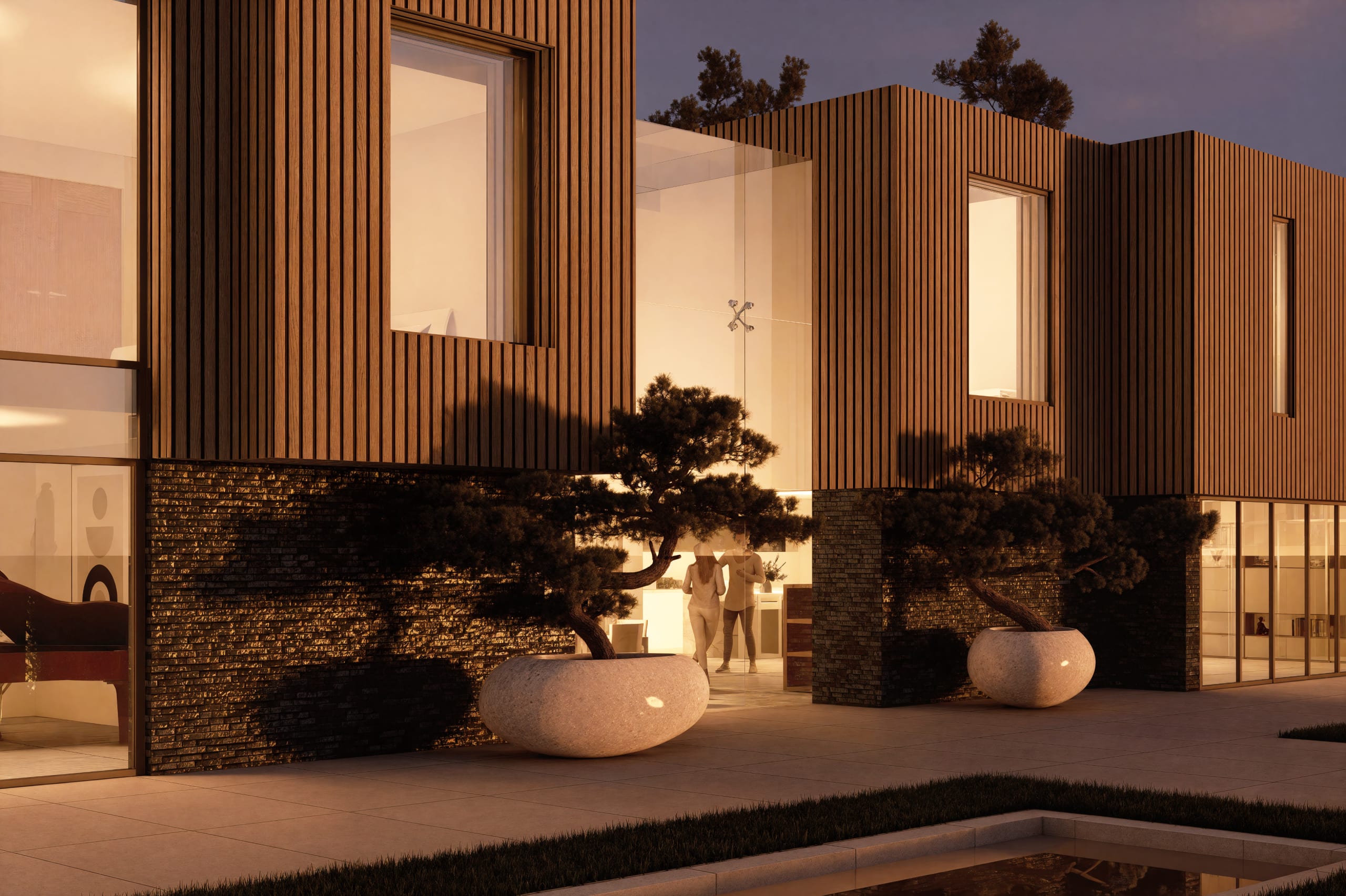 Modern residential building at dusk featuring vertical timber cladding, stone walls, sculptural planters with pine trees