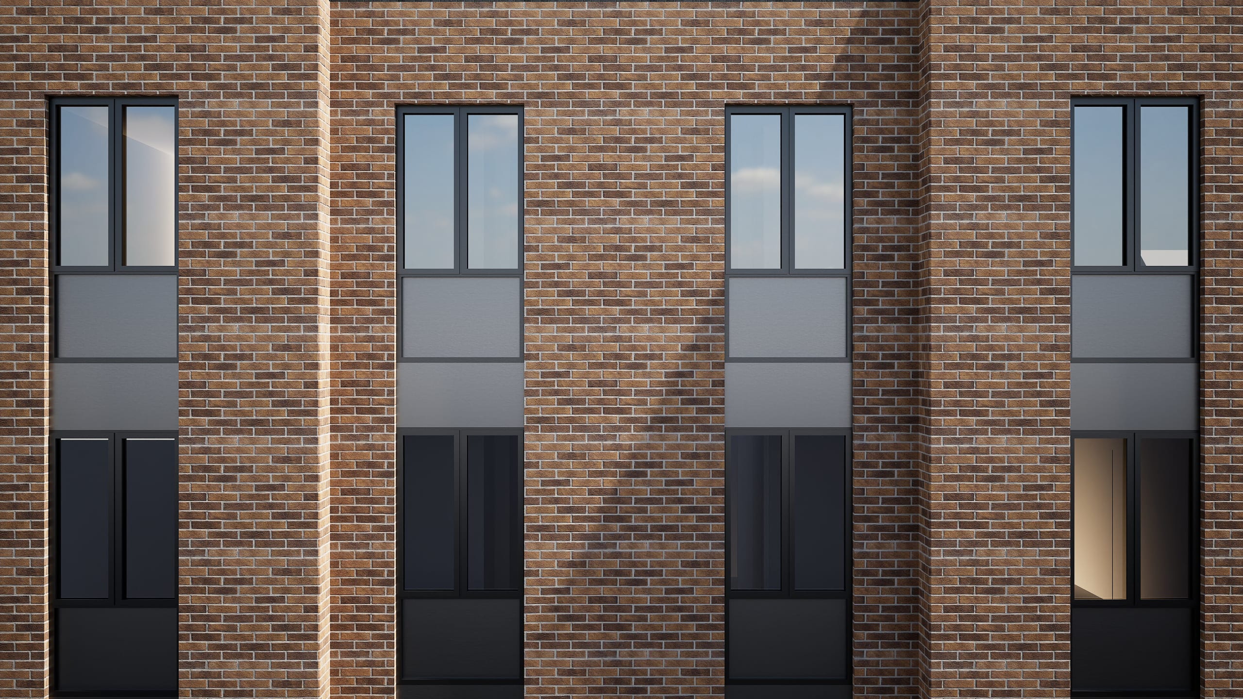 Modern brick building facade with tall vertical windows featuring dark metal frames arranged in a rhythmic pattern
