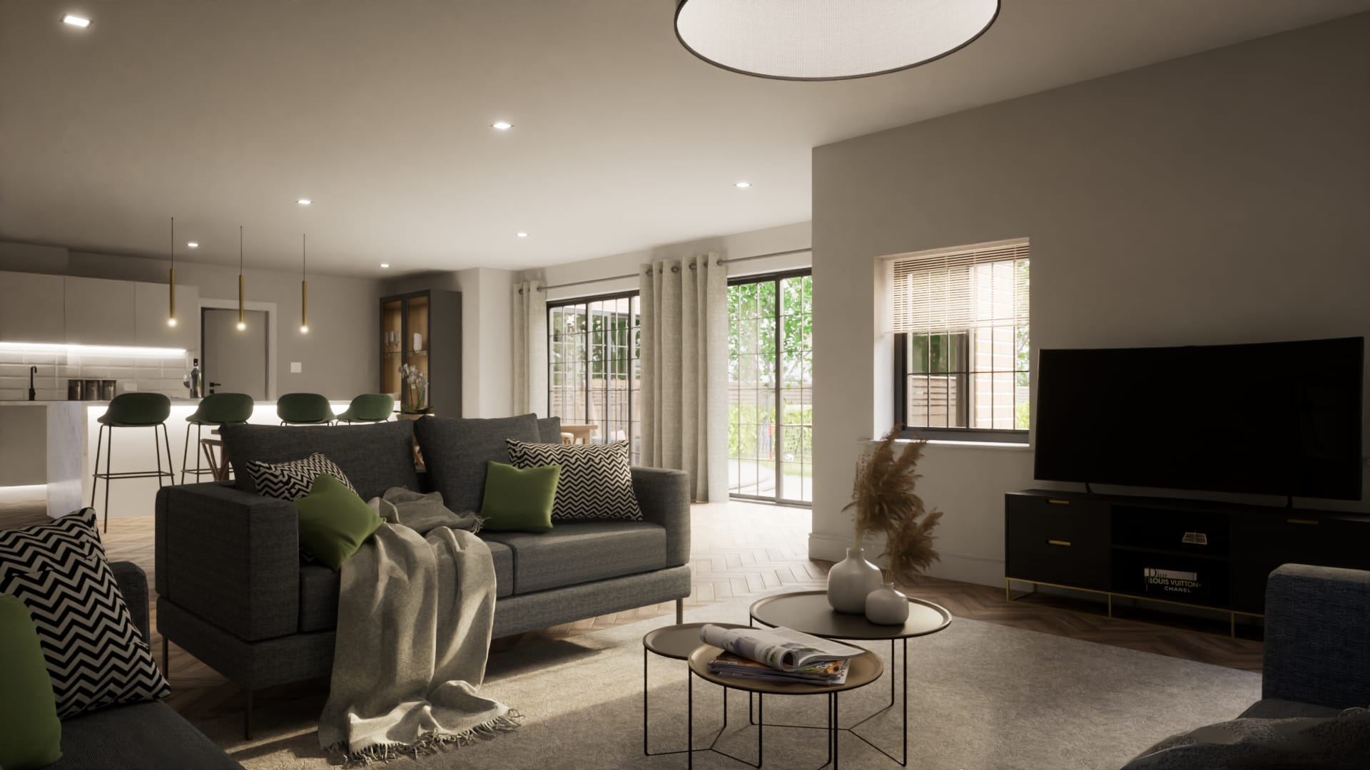 Modern open-plan living space with grey sofas, green accents, kitchen island with bar seating, and herringbone wood flooring