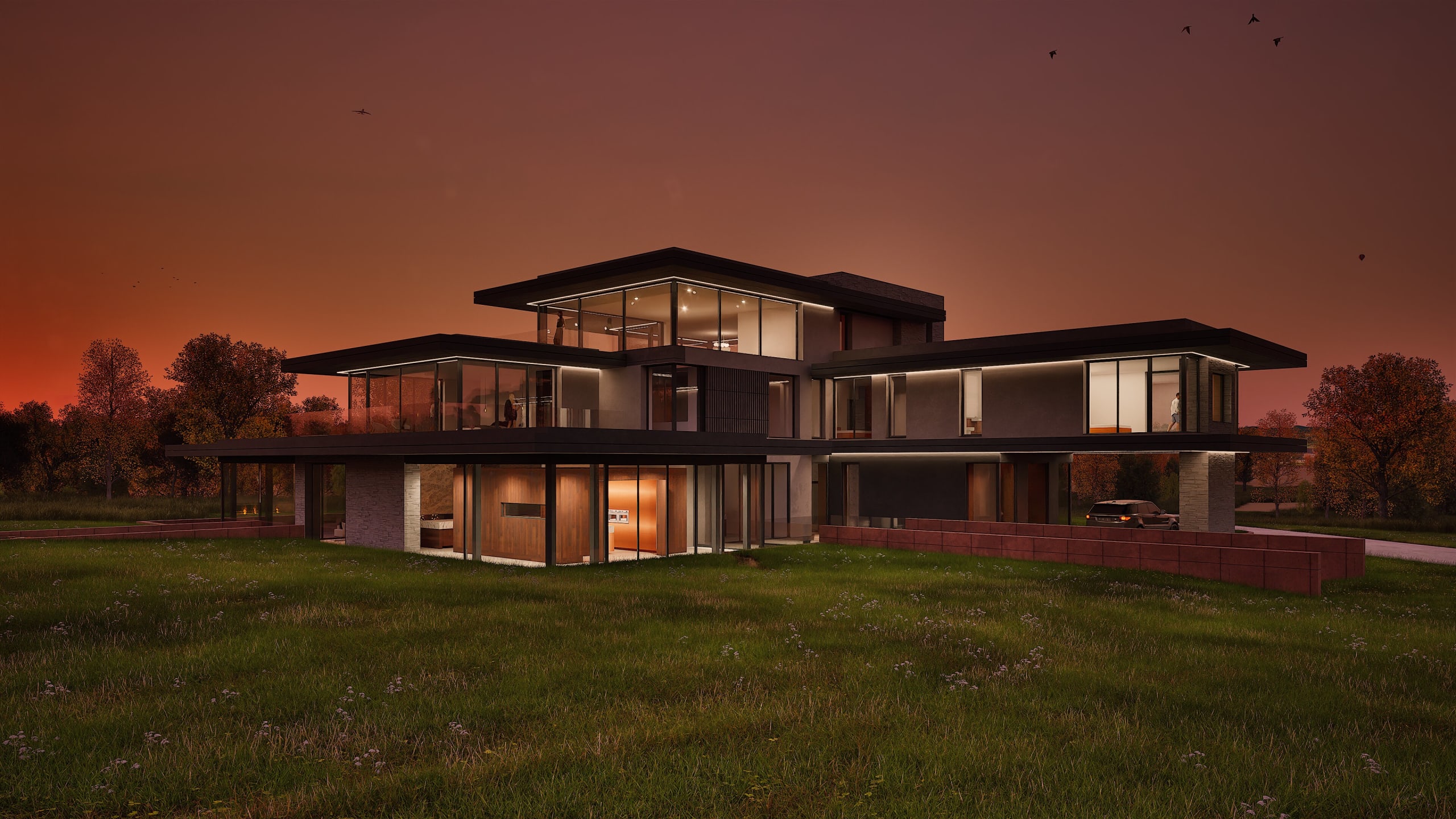 Modern three-story luxury home with expansive glass walls and flat roofs illuminated at dusk against orange sunset sky
