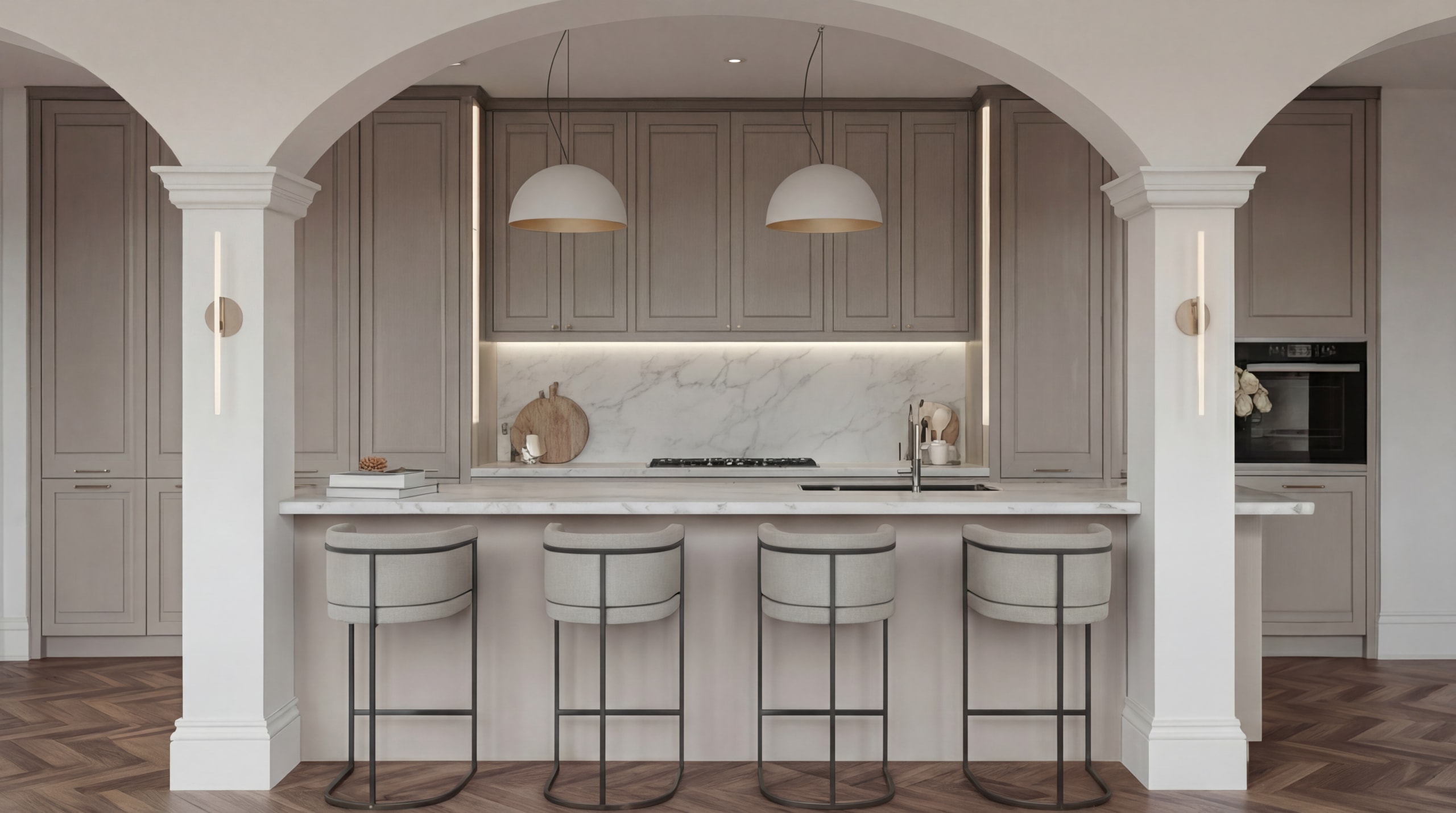 Modern kitchen with taupe cabinetry, marble backsplash, white island with four bar stools, and elegant arched entryways