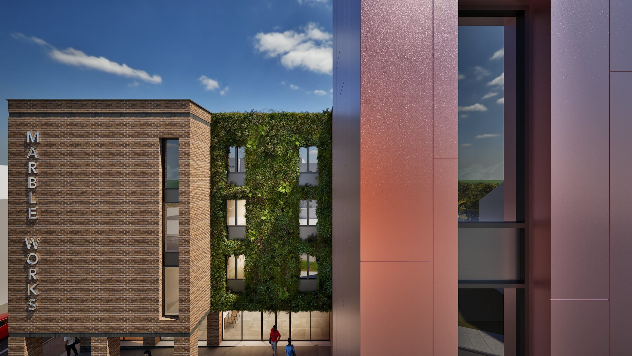 Modern mixed-use development featuring brick Marble Works building alongside living green wall facade and copper-clad tower