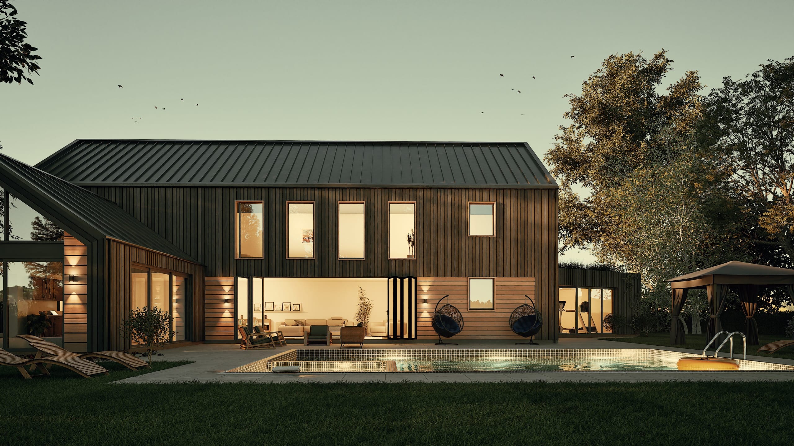 Modern barnhouse-style home with dark metal roof, vertical wood siding, large windows, pool, and outdoor living spaces at dusk