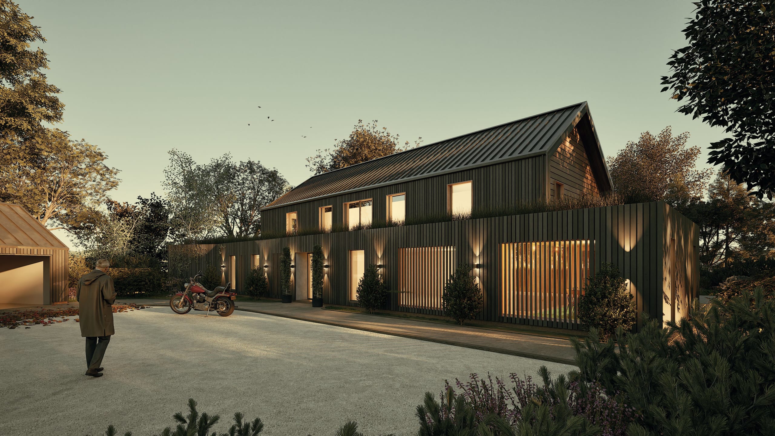 Modern barn-style home with dark vertical timber cladding, illuminated windows at dusk, featuring green roof and motorcycle