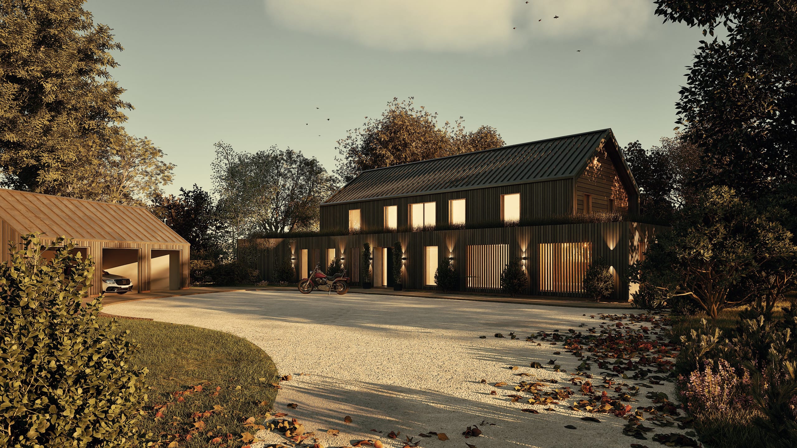 Modern barn-style home with dark vertical timber cladding, illuminated windows at dusk, detached carport and gravel drive