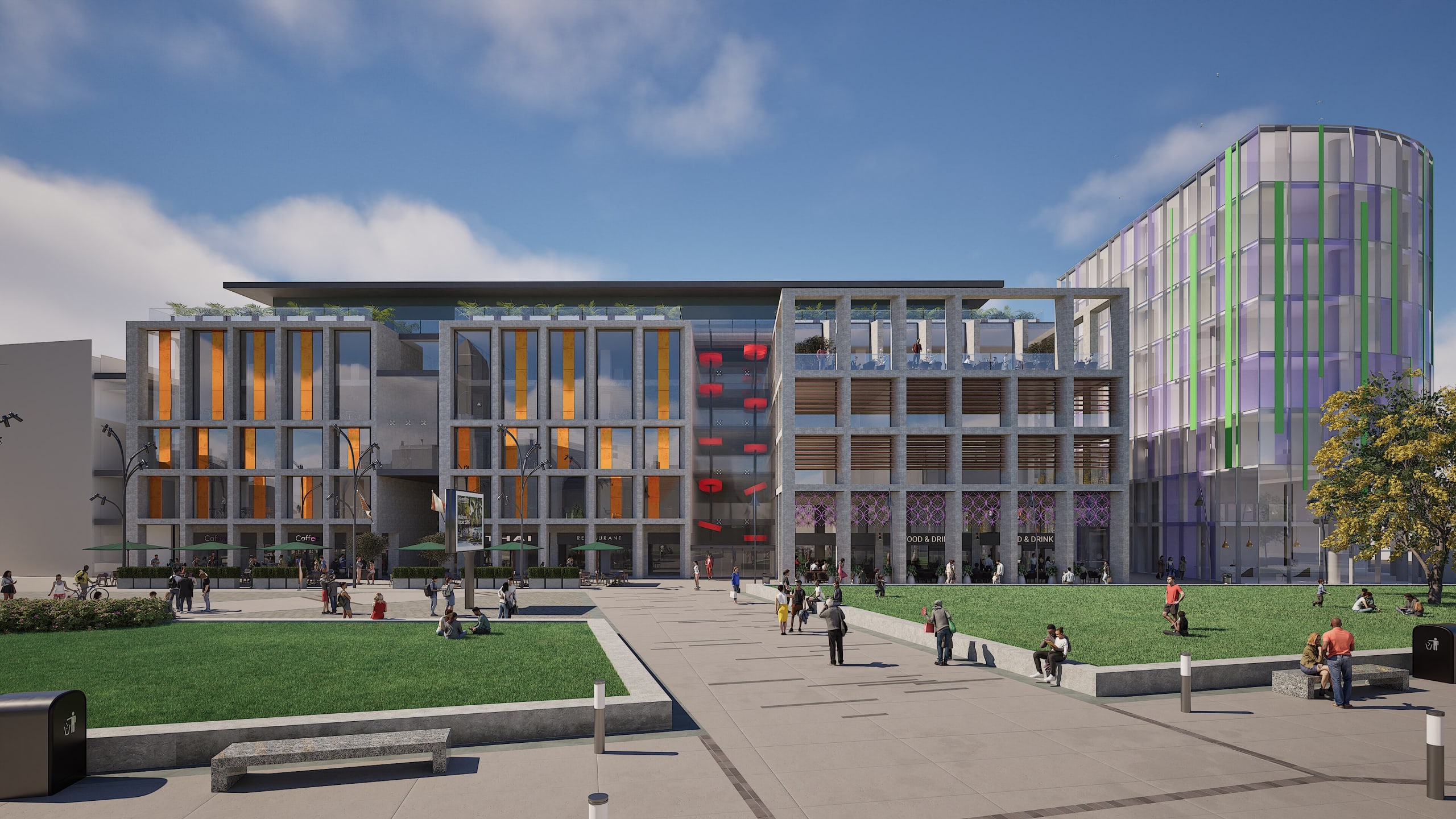 Modern mixed-use development with gray concrete facades, orange accent panels, green lawn plaza, and pedestrians walking