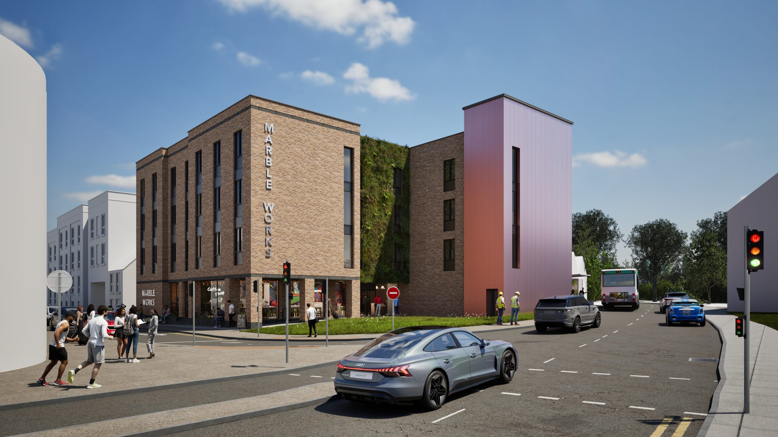 Marble Works mixed-use development with brick facade, green living wall, ground floor retail, and pink cladding tower