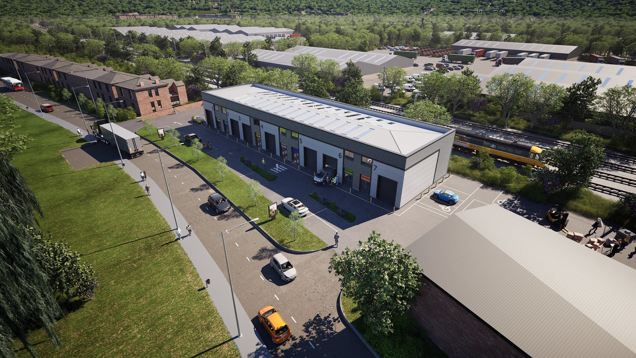 Aerial view of modern industrial warehouse units with numbered bays, parking areas, adjacent railway line and green landscaping