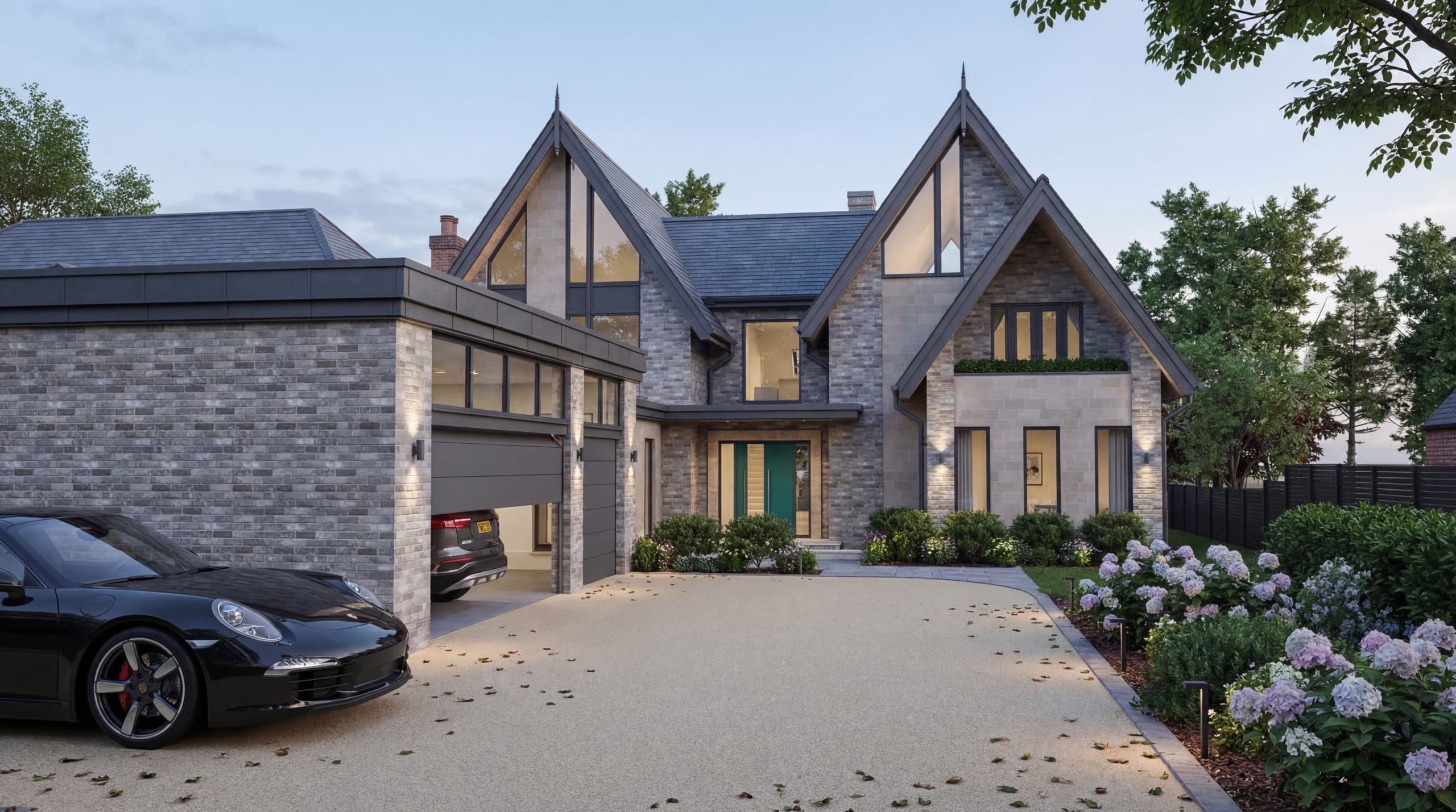 Twin-gabled contemporary home with grey brick facade, glazed gable ends, and integrated double garage at dusk