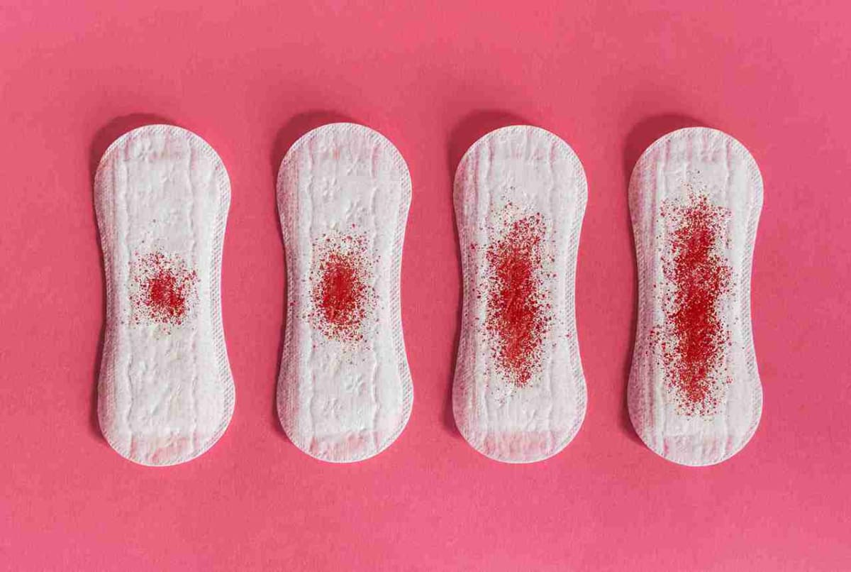 683d4c31758ebc7ce2207236_menstrual-pads-with-blood-stains-pink-background-concept-menstruation_11zon