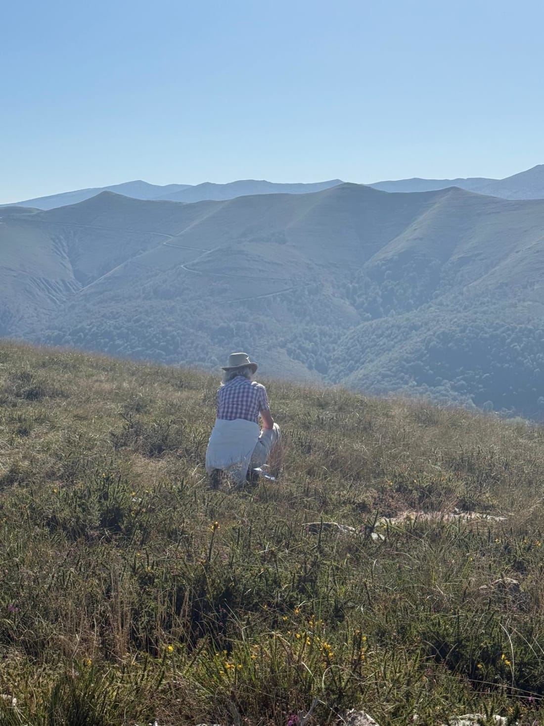 A walker on the ridge, the valley below